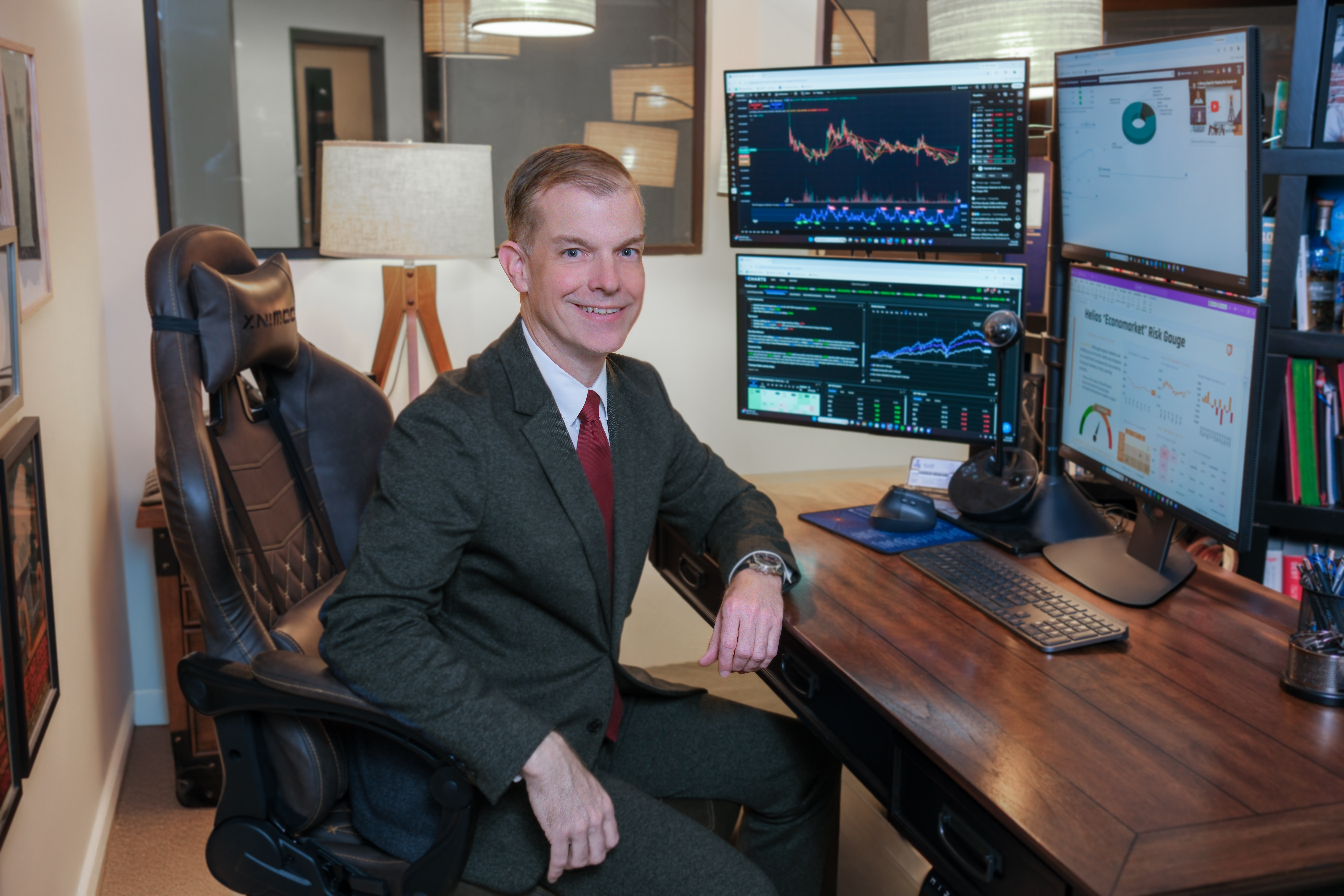 Brent Rupnow at his desk with the Helios research dashboard and live market data